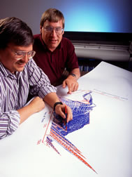 Computer specialist Ken Rojas (left) and range scientist Jon Hanson use the Root Zone Water Quality Model.