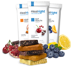 Three micronutrient bars surrounded by blueberries, raspberries, and cherries